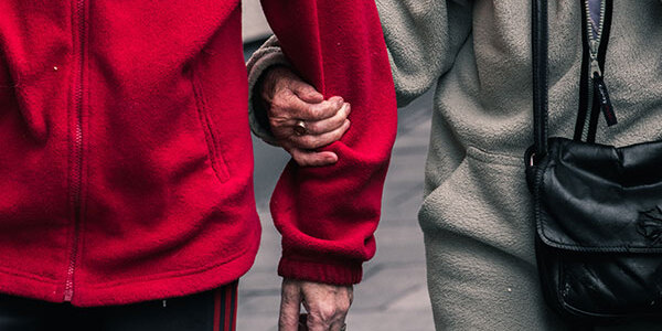 senior couple walking arm in arm