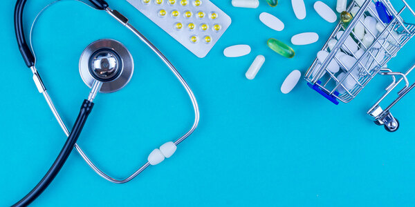stethoscope and medicine on a blue table